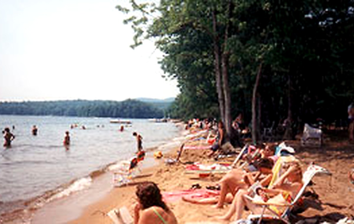 Sebago Lake State Park beach with swimmers and sandy shoreline