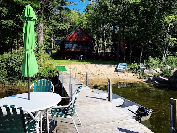 Dock and outdoor seating at Cozy Sebago Lake Retreat