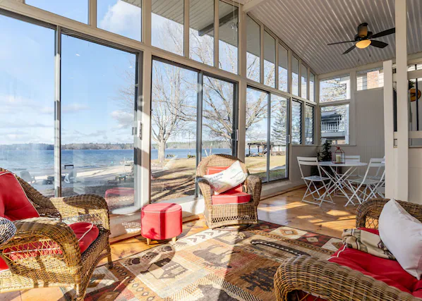 Sunroom with lake views at the Raymond beachfront home