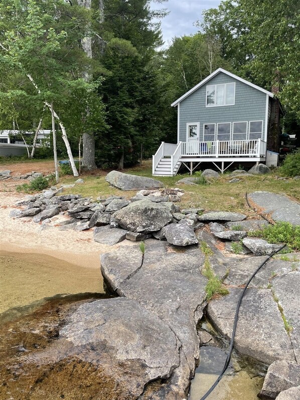 Exterior and porch of the rustic shorefront cottage