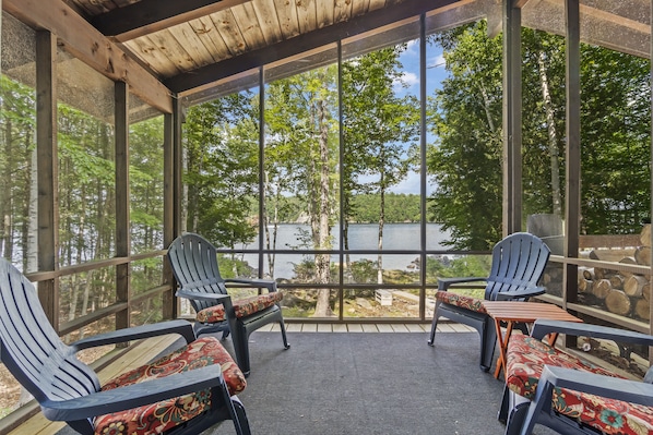Screened porch and lake view at the Frye’s Leap waterfront retreat