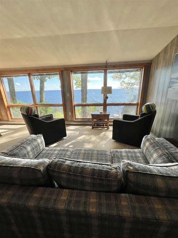 Lake-facing living room at the Sebago west-shore house